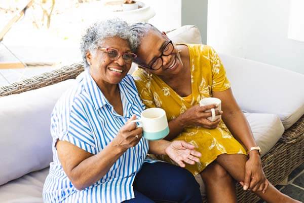 two women drinking coffee together
