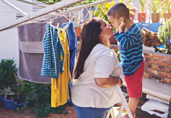 mom and son doing laundry outside