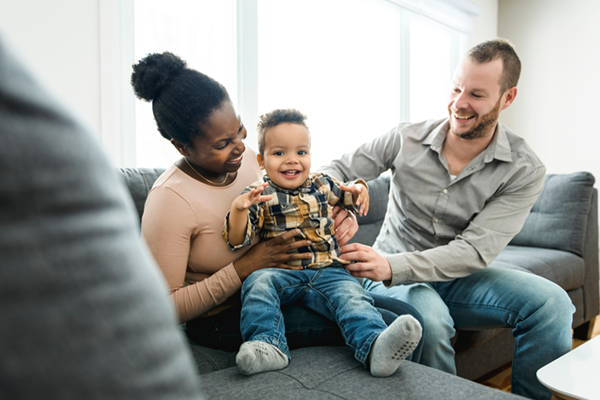 mother and father with child on couch